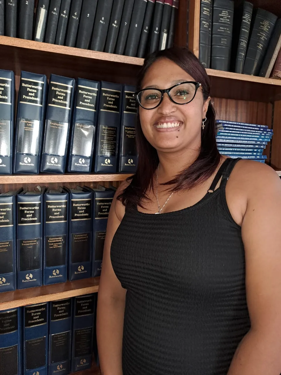 Conveyancing assistant in front of book shelf