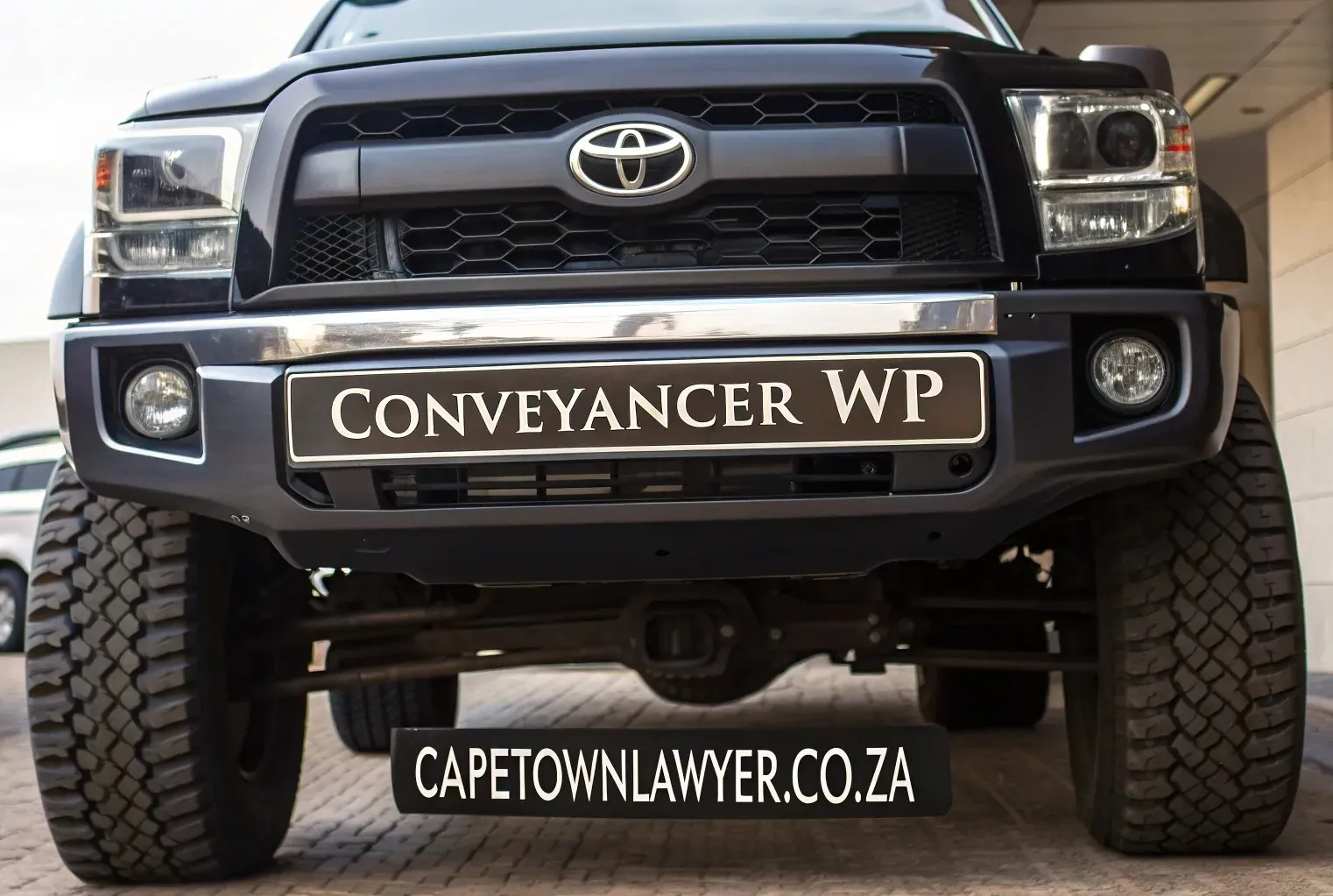 Car with number-plate CONVEYANCER WP, and CAPETOWNLAWYER.CO.ZA sign